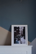 a photo in a white frame on a white mantle